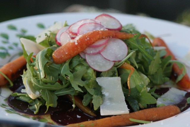 Spring salad with paper thin beets, baby carrots, radishes, arugula, and shaved parmeggiano
